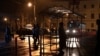 People wait at a tram stop during a blackout in Kyiv.