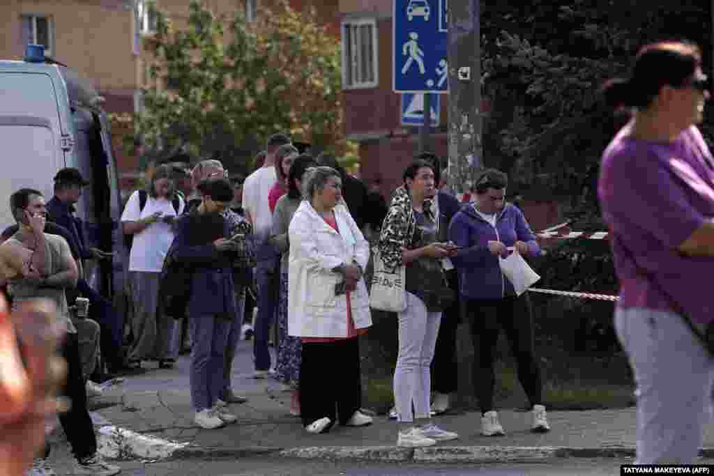 Residents gather outside the damaged apartment building in Ramenskoye following the drone attack. Russia&#39;s Defense Ministry reported that over 70 drones were downed in the Bryansk region, with dozens more intercepted in other areas. No damage or casualties were reported in these regions. &nbsp;