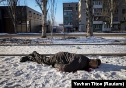 The body of a local resident lies in an empty street in the frontline city of Bakhmut on February 8.