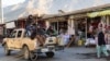 Taliban soldiers ride in a car on a street in Panjshir in December 2021.