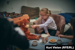 Eva, 5, plays with the recreation center's stuffed animals.