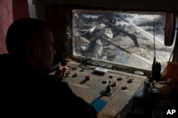 A worker controls the extraction of ilmenite, a key element used to produce titanium, in an open pit mine in Ukraine's central Kirovohrad region.