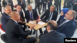 Turkish President Recep Tayyip Erdogan (center-right), accompanied by Foreign Minister Mevlut Cavusoglu, chats with Azerbaijani President Ilham Aliyev (front left), Armenian Prime Minister Nikol Pashinian (front right), and Hungarian Prime Minister Viktor Orban (back right) at the European Political Community in Prague on October 6.