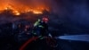 A firefighter works at the site of a warehouse heavily damaged during a Russian missile strike in Kyiv on December 29.