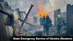 In a handout photo from Ukraine's Emergency Service, firefighters work at the site of a Russian missile strike in Odesa on March 15. 