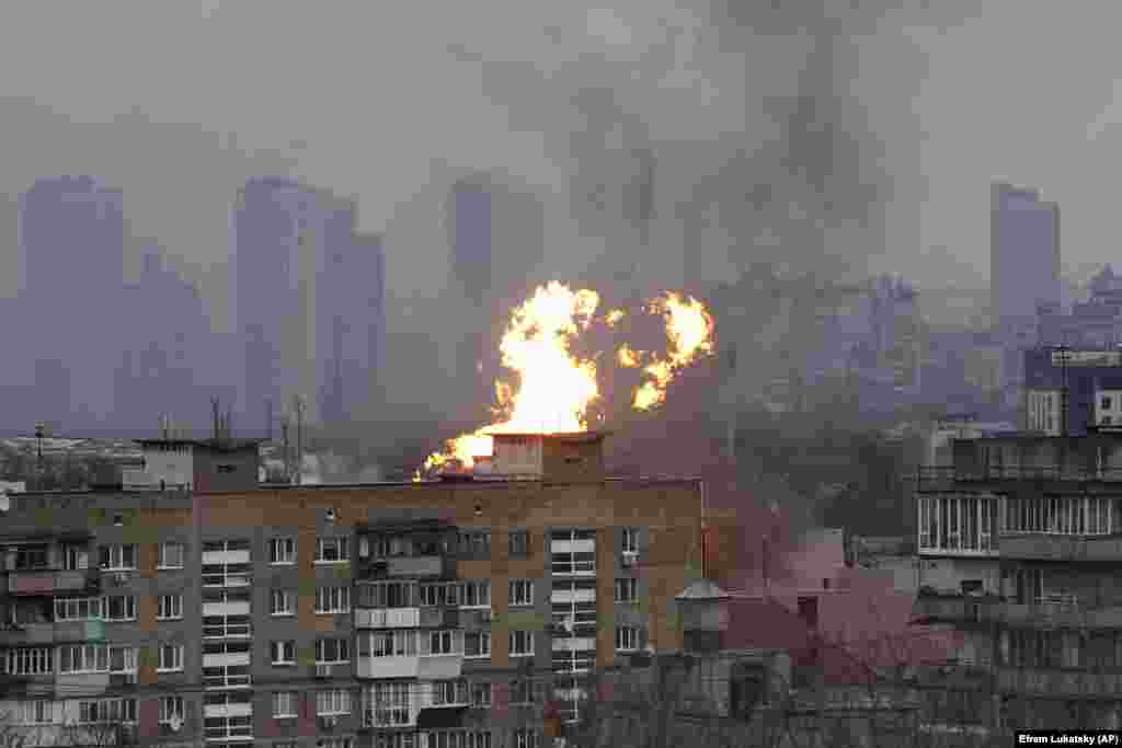 Flames and smoke rise above a residential building following the attack on Kyiv.