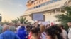 Demonstrators protest the presence of a cruise ship carrying Russian passengers in the Georgian port of Batumi on July 27