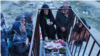 Mourners at the grave of Mehdi Babrinejad who was killed by Iranian security forces during protests last year. 