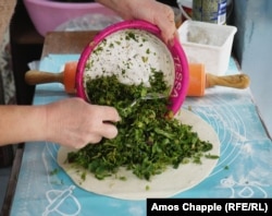 A refugee from Nagorno-Karabakh prepares a jingalov hat at a bakery in Echmiadzin, near Yerevan.