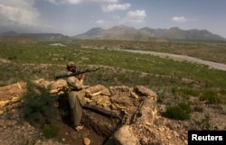 A Pakistani soldier holds a rocket launcher while standing in a bunker on a hill in Sadda, a town in Khyber Pakhtunkhwa close to the Afghan border.