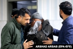 Relatives console a man who lost his loved ones in a blast that targeted a police vehicle in Bajaur on January 8.