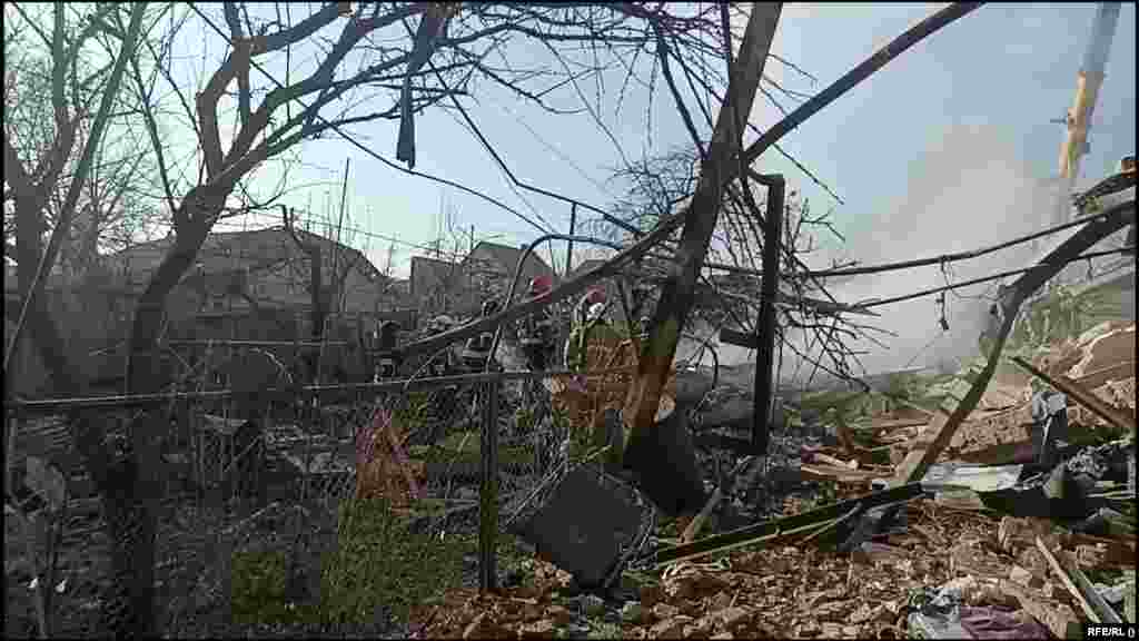 Emergency responders work at the scene of a Russian missile attack in&nbsp;Khmelnytskiy in western Ukraine on March 21. Local authorities&nbsp;reported&nbsp;that one person had been killed and several wounded.