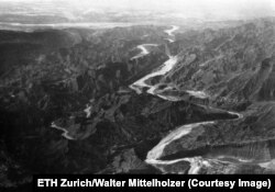 A river cuts through an unidentified Persian mountain range.