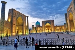 People visit Samarkand's Registan Square at sunrise.