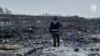 A rescue worker surveys the site of a Russian military plane crash in the Belgorod region on January 24.