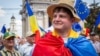 A young man wearing a Moldovan flag across his shoulders takes part in a pro-EU rally in Chisinau. (file photo)