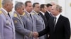 Russia's President Vladimir Putin (right) greets Interior Minister Vladimir Kolokoltsev (left), Russia's Defense Minister Sergei Shoigu (second left), and Viktor Zolotov (third right), head of Russia's Federal National Guard Service, at a ceremony at the Kremlin in 2019.