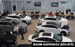 People visit a store selling the Chinese car Changan in Podolsk, outside Moscow, in October 2023.