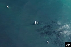 A tanker is photographed by satellite taking on Iranian oil in Asia.