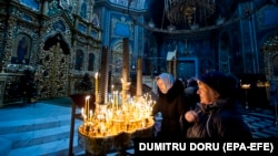 Believers light candles during the service for Orthodox Epiphany celebrations in the Nasterea Domnului Cathedral in Chisinau in January.