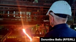 Fehmi Nika, the head of the workers' union at the nickel plant, watches the production floor.