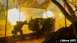 A Ukrainian soldier of the 10th Assault Brigade Edelweiss fires a D-30 cannon toward Russian positions at the front line near Bakhmut, Donetsk region, Ukraine, on July 5.