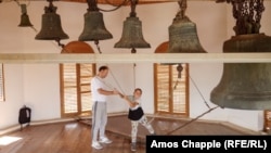 A boy being taught to ring church bells in the Lipovan village of Carcaliu on May 7