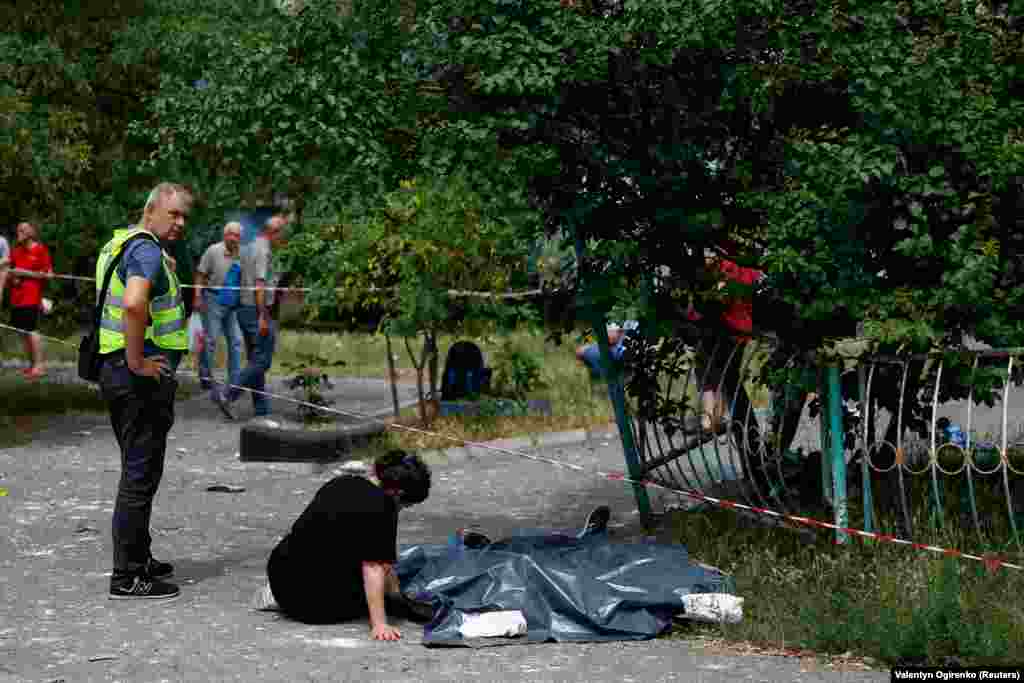 A woman sits next to the bodies of her relatives killed during the missile attack. Russian forces have repeatedly targeted the capital with massive barrages since Moscow began its full-scale invasion in February 2022. The last major attack on Kyiv with drones and missiles was last month. &nbsp;