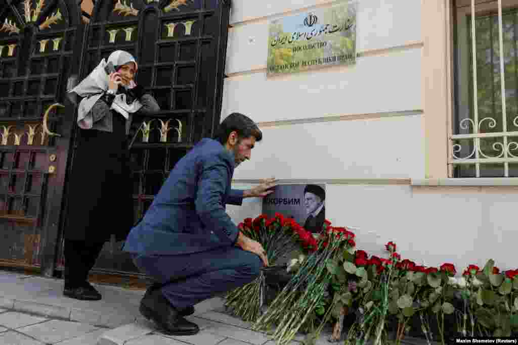 Flowers and a card that reads, &quot;We mourn&quot; are left near the Iranian Embassy in Moscow. Russian President Vladimir Putin praised Raisi as an &quot;outstanding politician,&quot; and &quot;a true friend of Russia.&quot;