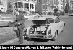 A man preparing to charge his EV at an unidentified location in the United States in February 1974.