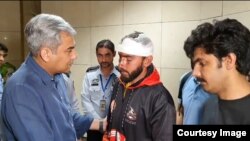 Pakistani Interior Minister Mohsin Naqvi (left) greets a student injured in the Bishkek attacks, at Lahore airport on May 18. The Pakistani Embassy in Bishkek announced special flights to bring students home over the next few days. 