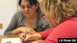 Rozina, a Rom from Ukraine's Transcarpathia region, practices her writing with Agnes Pletser from the Taleta NGO.