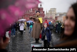 A participant dressed in Red Army World War II uniform performs at an open-air interactive museum to commemorate the 82nd anniversary of the World War II-era parade, at Red Square, in Moscow on November 6, 2023.