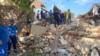 Emergency personnel work at the scene of the destroyed shopping center in Apsheronsk on July 22.