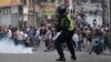 A riot police officer uses tear gas against demonstrators during a protest by opponents of Venezuelan President Nicolas Maduro's government in the Catia neighborhood of Caracas on July 29, a day after the Venezuelan presidential election. 