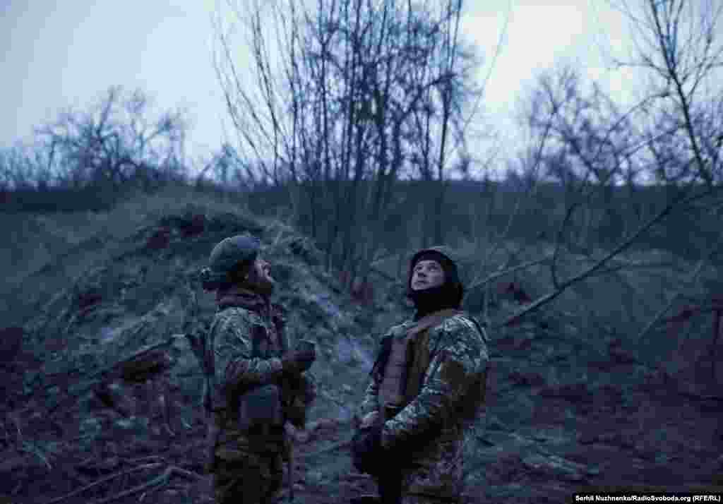 Ukrainian troops watch the sky for enemy drones at a position near Bakhmut on March 6, 2024.&nbsp;