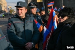 People waved Russian and Armenian flags as Yerevan hosted a Security Council session of the Collective Security Treaty Organization on November 23.