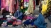 Afghan women sell secondhand clothes in the Jada-e Maiwand area in Kabul on January 17.