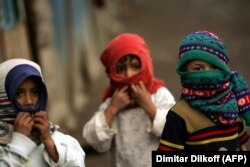 Boys cover their nose and mouths at the Zitkovac camp in 2007.