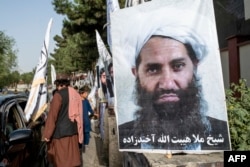 A poster of Taliban Supreme Leader Hibatullah Akhundzada is seen along a road in Kabul.