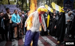 Demonstrators in Tehran burn an effigy of Trump during an annual anti-US rally on November 11, 2017.