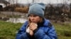 A 9-year-old girl named Sofiyka hugs her guinea pig during her evacuation from Makiyivka, in Ukraine's eastern Luhansk region, on November 19, 2022.