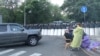 Anti-government protesters gather on a main road in downtown Yerevan where police were guarding access to Armenia's parliament on June 10.