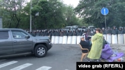 Anti-government protesters gather on a main road in downtown Yerevan where police were guarding access to Armenia's parliament on June 10.