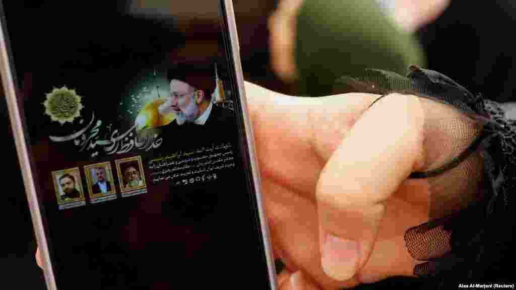 An Iranian Shi&#39;ite pilgrim in the holy city of Najaf, Iraq, shows the news on her phone announcing the death of Raisi. The ultraconservative Raisi was widely tipped to become the country&#39;s next supreme leader.