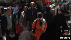 A woman walks on a street in Tehran amid the implementation of the new hijab surveillance system.