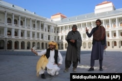 Afghans take selfies at the renovated Darul Aman Palace in the Afghan capital, Kabul.