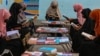 Afghan girls read at a library in Jalalabad. The Islamist group has barred girls from attending school past the sixth grade and banned women from going to university.