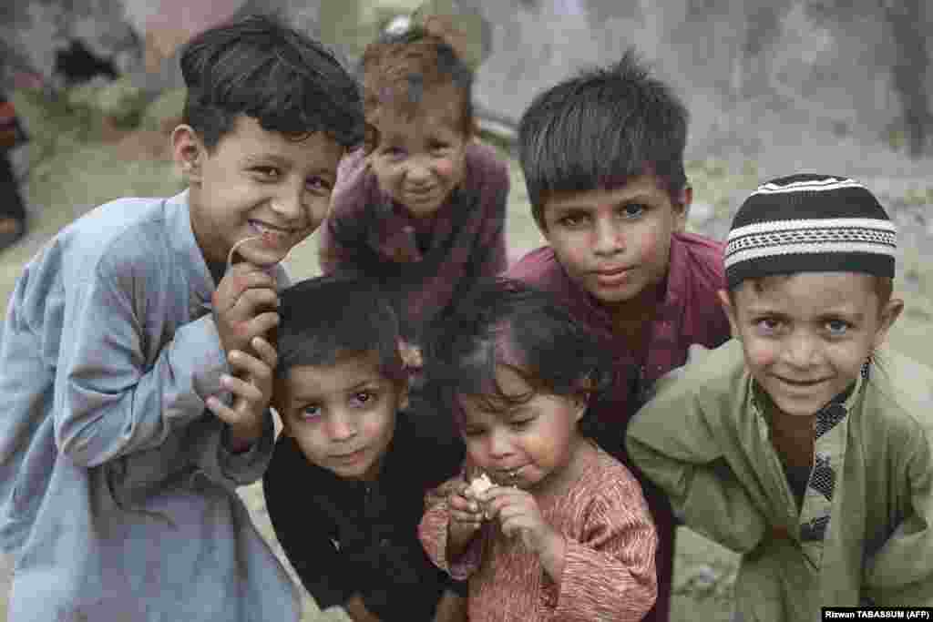 Afghan children pose for a photo at an Afghan refugee camp in Karachi on September 21. Local media reported that the caretaker government in Islamabad approved the move on September 26 to repatriate over 1.1 million Afghan nationals living illegally in the country back to Afghanistan. However, no official confirmation has been released from the interim government.&nbsp;