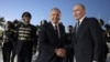 Uzbek President Shavkat Mirziyoev (left) greets Russian President Vladimir Putin at the airport in Tashkent on May 25.